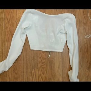White, long sleeve crop top. Open lace back.
